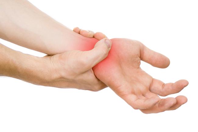 Close-up of someone holding their wrist in pain