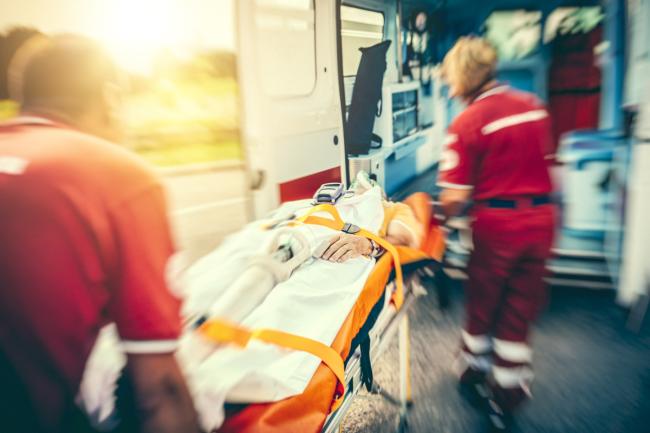 20201124-cardiac-arrest.jpg Rescue team bringing person to ambulance