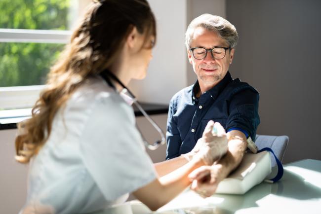 20220110-alz.jpg Image of a man getting blood drawn