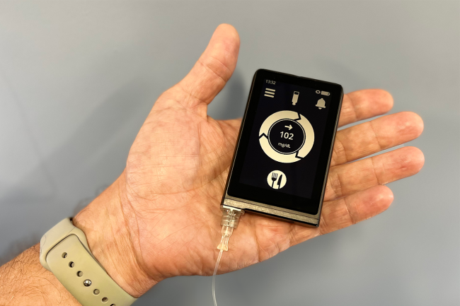 20221013-pancreas-crop.png Hand holding a device that looks like a small smartphone
