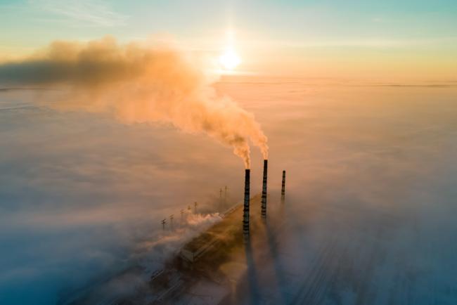 20231212-pollution.jpg Aerial view of coal power plant with dark smoke at sunset.