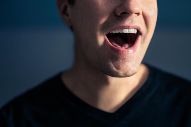 20240326-speech-breathing.jpg Close-up photo of the mouth of a man singing.