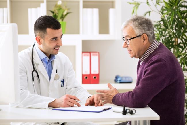 20240507-prostate.jpg Doctor talking to older male patient.