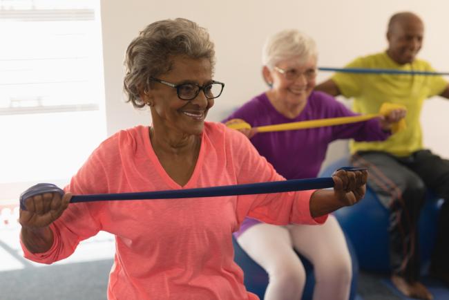 Senior woman exercising with resistance bands.