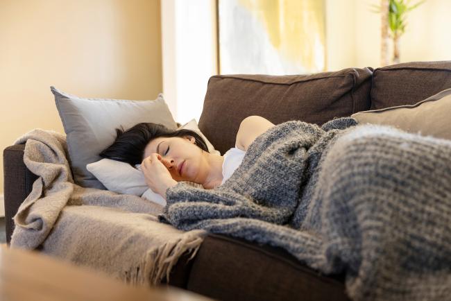 Exhausted woman lying on a sofa.