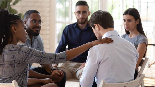 Rear view at upset man feel depression get psychological support