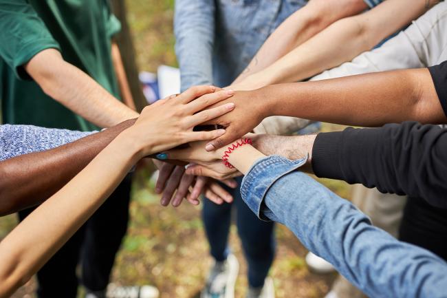 close-up photo of diverse people's hands gathered together