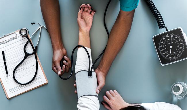 Image of a nurse taking a patient's blood pressure.