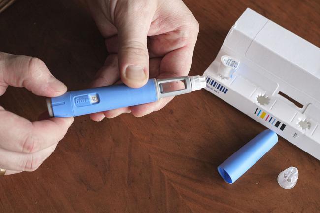 man preparing Semaglutide Ozempic injection control blood sugar levels