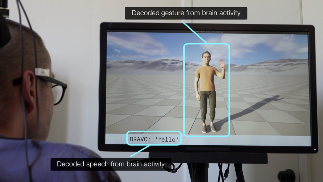 A person with a brain implant views a screen displaying a human avatar