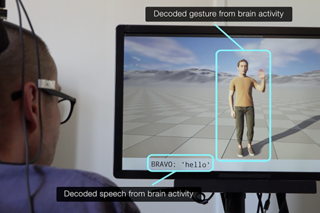 A person with a brain implant views a screen displaying a human avatar