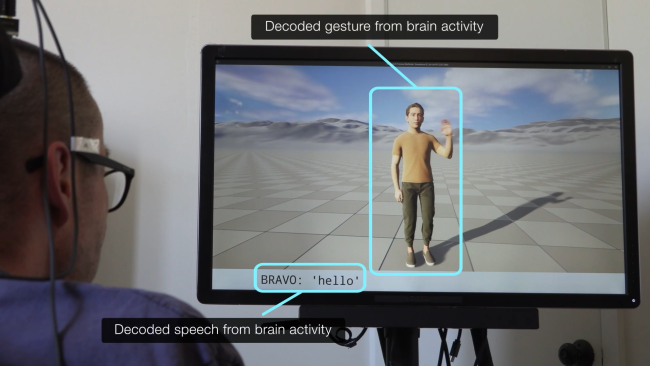 A person with a brain implant views a screen displaying a human avatar
