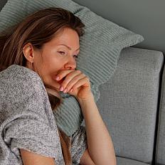 Tired woman lying on sofa.