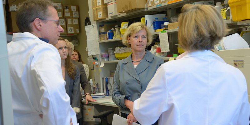 Senator Tammy Baldwin (WI) with NIH researchers at the National Cancer Institute who are working on childhood cancer immunotherapies.