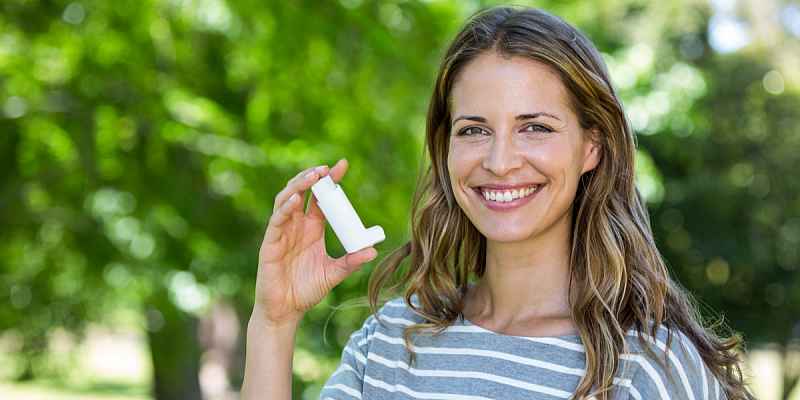 Photo of a woman holding an inhaler