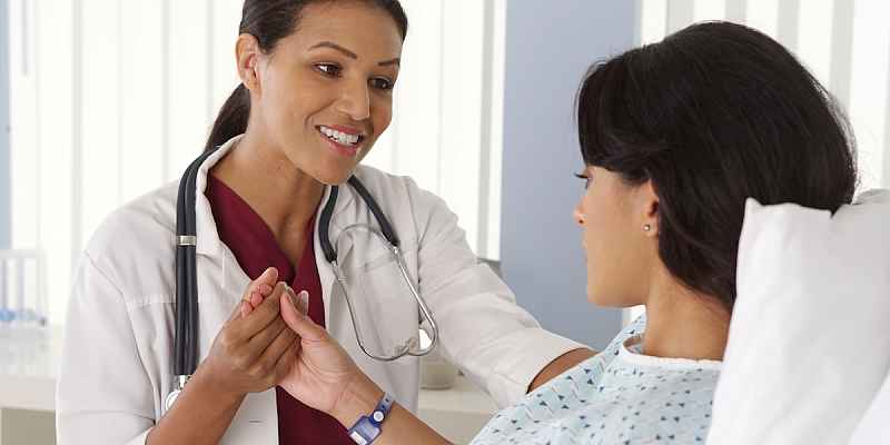 A doctor holding a patient's hand.