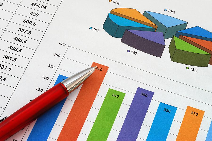 A pen resting on top of a printout of a bar chart
