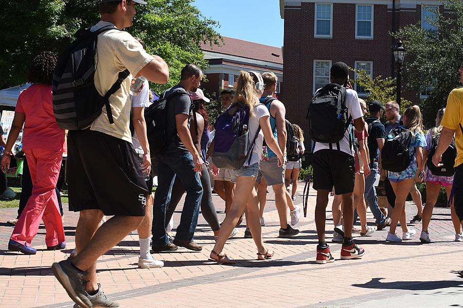 College students walking across campus 
