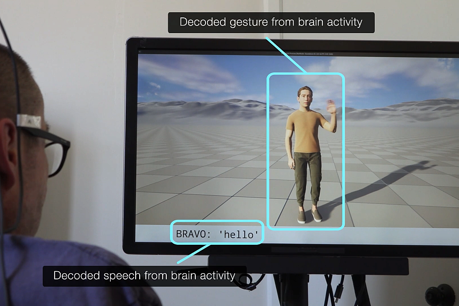 A person with a brain implant views a screen displaying a human avatar