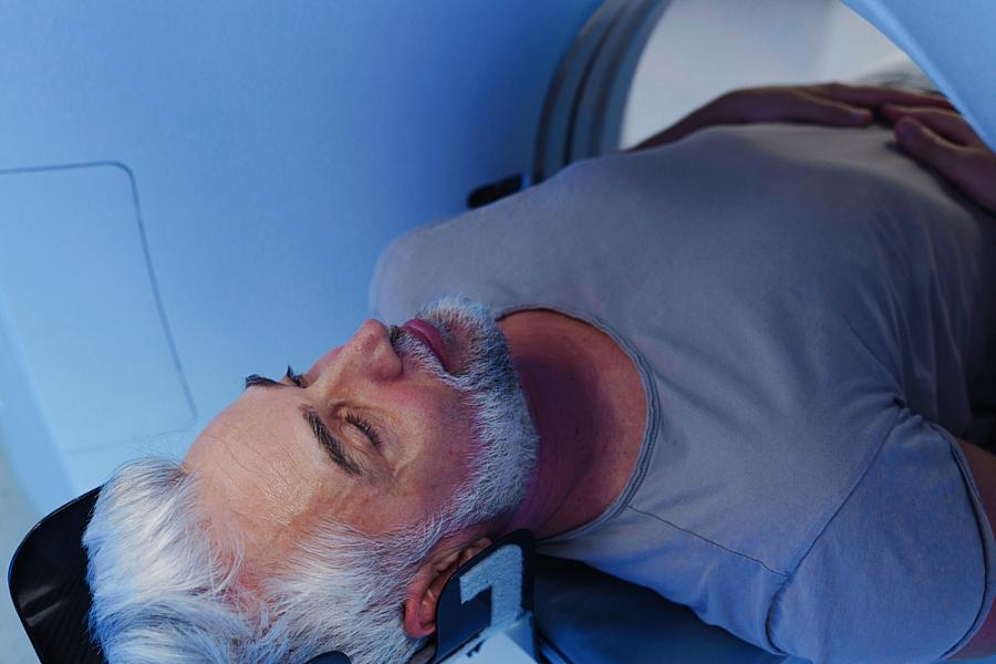 Male patient undergoing CT scan examination in hospital.