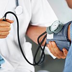 A doctor listening to his patient's heartbeat with a stethoscope