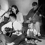 Francis S. Collins as a toddler (lower right), around 1951, taking part in a jam session at the family home in Virginia’s Shenandoah Valley. Back row, from left: Brandon Collins; mother, Margaret James Collins, father, Fletcher Collins Jr.; Front row, fro