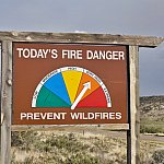 Fire danger roadside sign with arrow pointed to very high