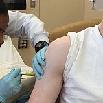 Image of a patient receiving a vaccine injection.