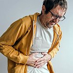 A man holding his stomach in pain
