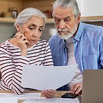 A mature couple looking at documents