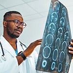 A radiologist reviewing a computed tomography (CT) scan of a patient's brain