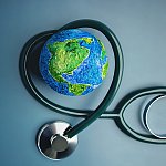 A stethoscope wrapped around a model of the earth