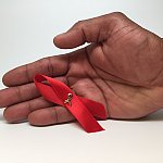 Image if a hand holding a ribbon