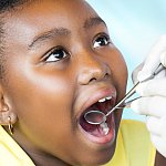 Image of a girl receiving a dental exam