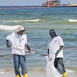 Image of men cleaning up a beach