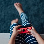 A child holding  a video game controller.