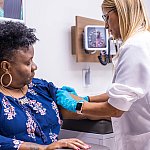 Image of a researcher collecting a blood sample