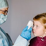 A child getting temp check.