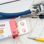  Diuretic drug for heart, kidneys and cardiovascular system. Packing of pills with inscription "Diuretic Medication" for treatment of cardiovascular diseases near EKG