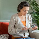 Image of a woman measuring blood sugar level