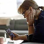 Image of a woman talking with a doctor via smartphone.