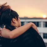 Image of two women sitting on a rooftop