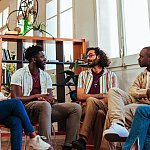 Five diverse young people having a conversation with psychologist during a group therapy session.