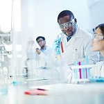 Image of three young scientists working in a lab