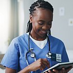 Image of a doctor looking at a tablet device.