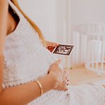 Image of an expectant mother looking at a sonogram of twins