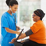 a photo of a woman having her blood pressure taken