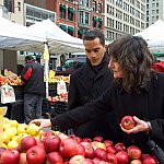 Photo of two people at an outdoor fruit stand