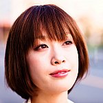 Photo of an optimistic young Japanese woman cropped