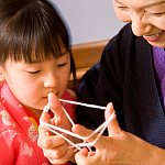 Female Asian senior citizen and her granddaughter.